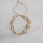 Cowrie shell bracelet with golden details