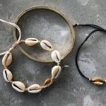 Cowrie shell bracelet with golden details