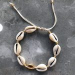 Cowrie shell bracelet with golden details